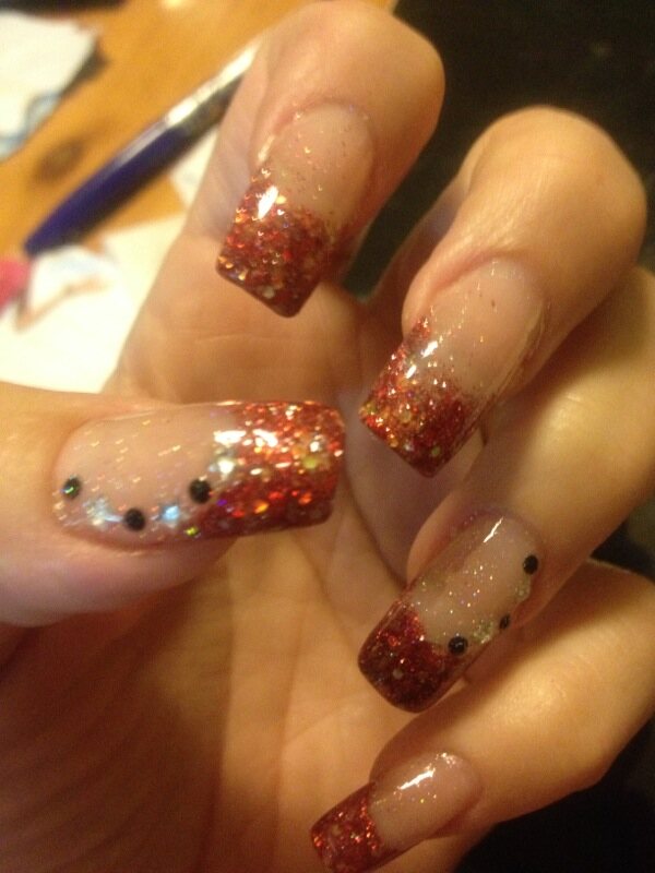 Red glitter nail enhancements with crystal details